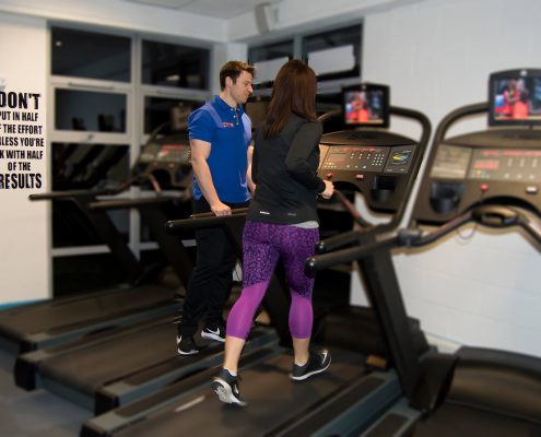 Personal Trainer Darren helping his client in our Swansea Gym